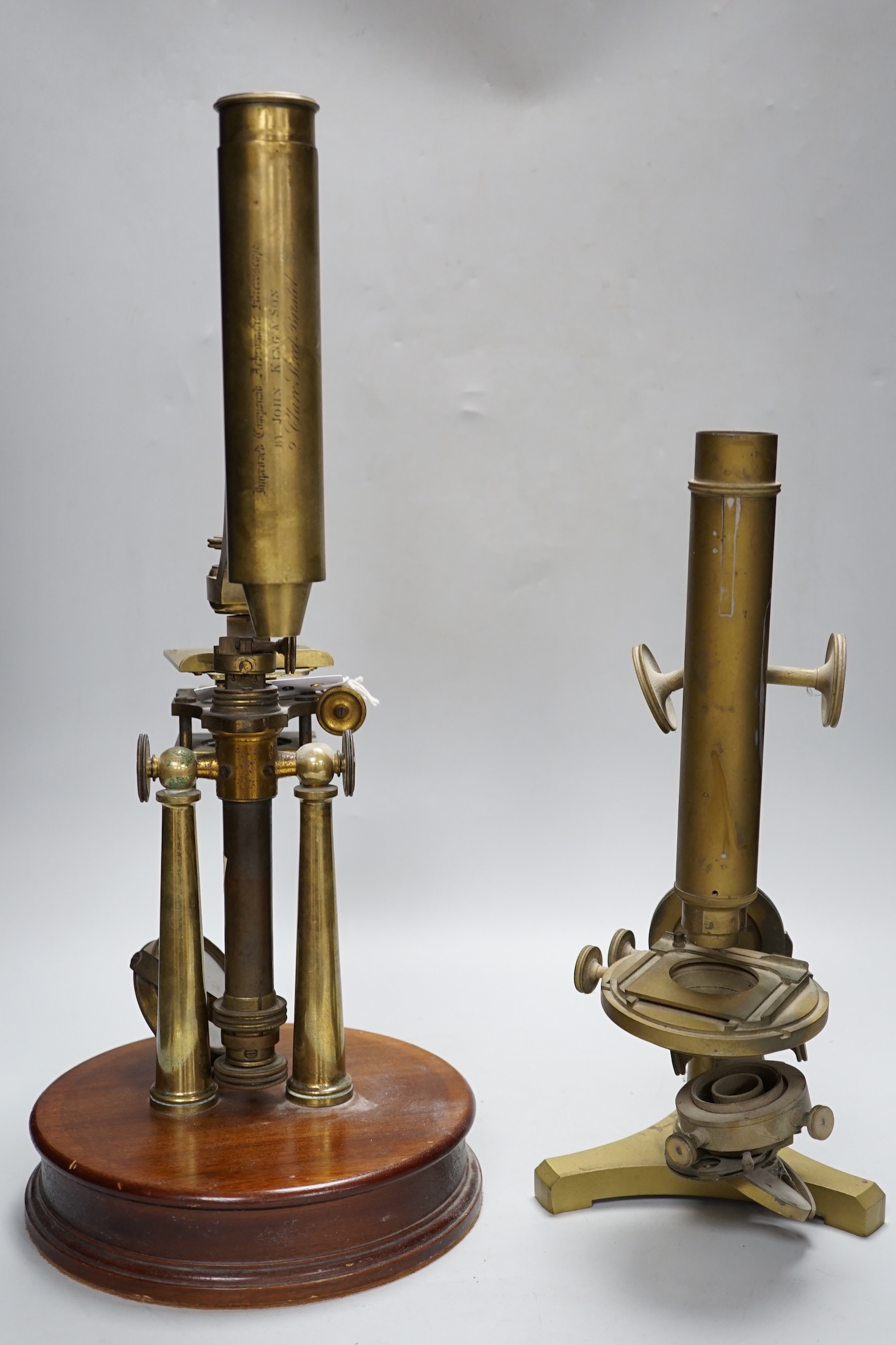 Three antique brass microscopes, one stamped R & J Beck London & Philadelphia, 37cm high